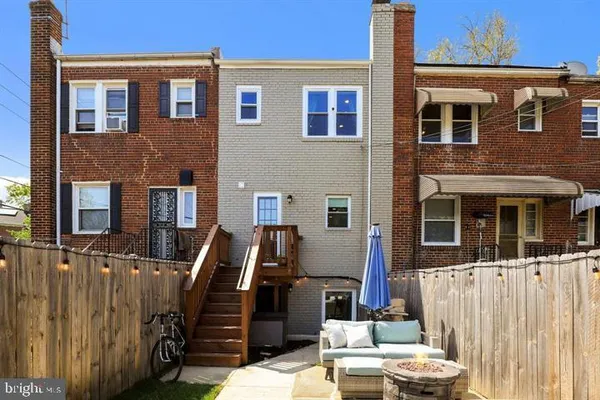 a view of a house with a sink and a wooden fence