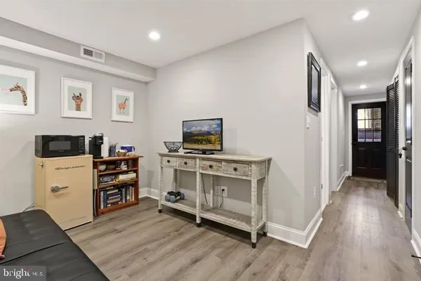 a view of a kitchen with fridge and wooden floor