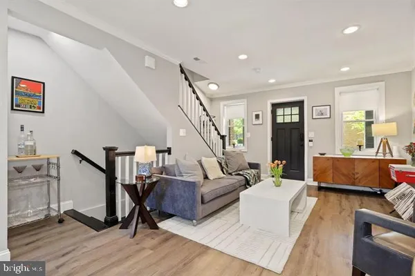 a living room with furniture and a wooden floor