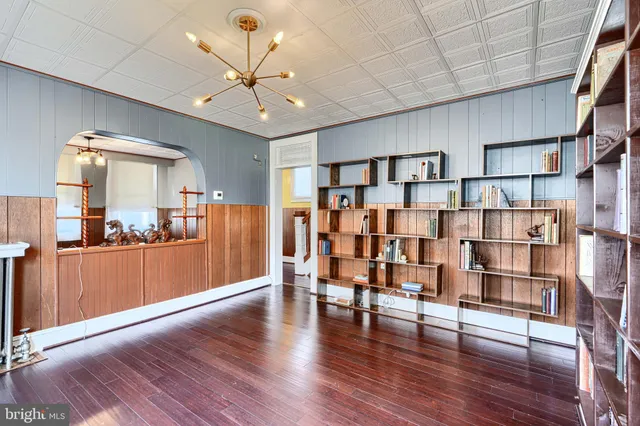 a open kitchen with stainless steel appliances wooden floors and view living room