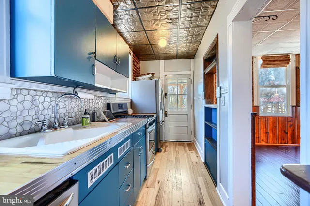 a kitchen with stainless steel appliances granite countertop a stove and a microwave