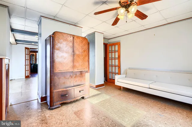 an entryway of a house with wooden floor and windows