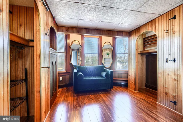 a view of empty room with wooden floor and window