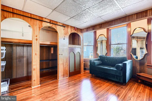 a white bath tub sitting next to a white sink and a shower
