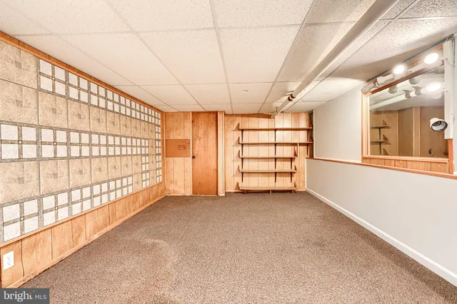 a backyard of a building with barbeque oven table and chairs