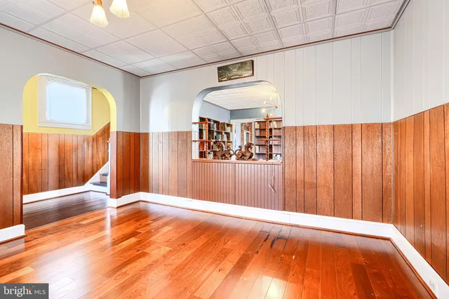 a view of a livingroom with wooden floor and a window