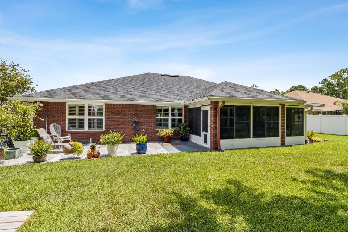 88033 Maybourne Road Yulee, FL 32097 - Photo 2 of 42 a front view of house with yard and porch