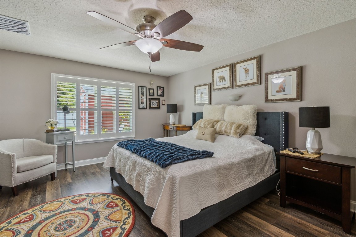 88033 Maybourne Road Yulee, FL 32097 - Photo 22 of 42 a bedroom with a bed a couch and a window