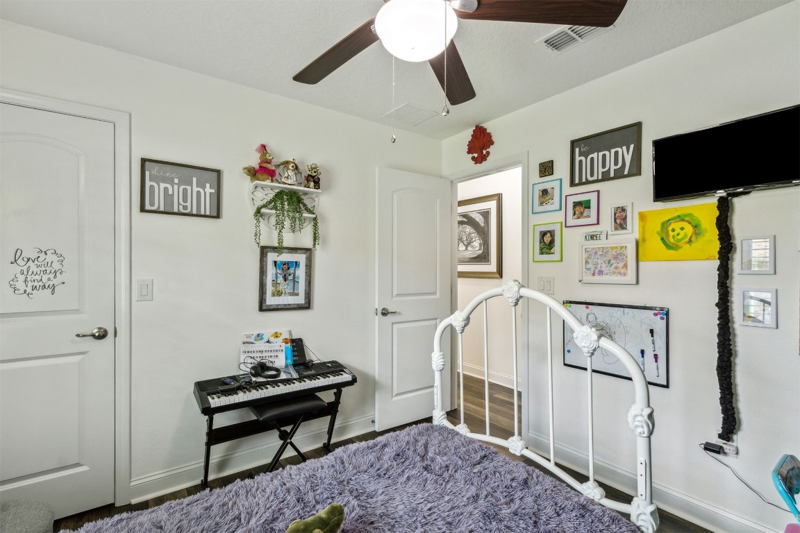 88033 Maybourne Road Yulee, FL 32097 - Photo 28 of 42 a bedroom with a bed and a chandelier