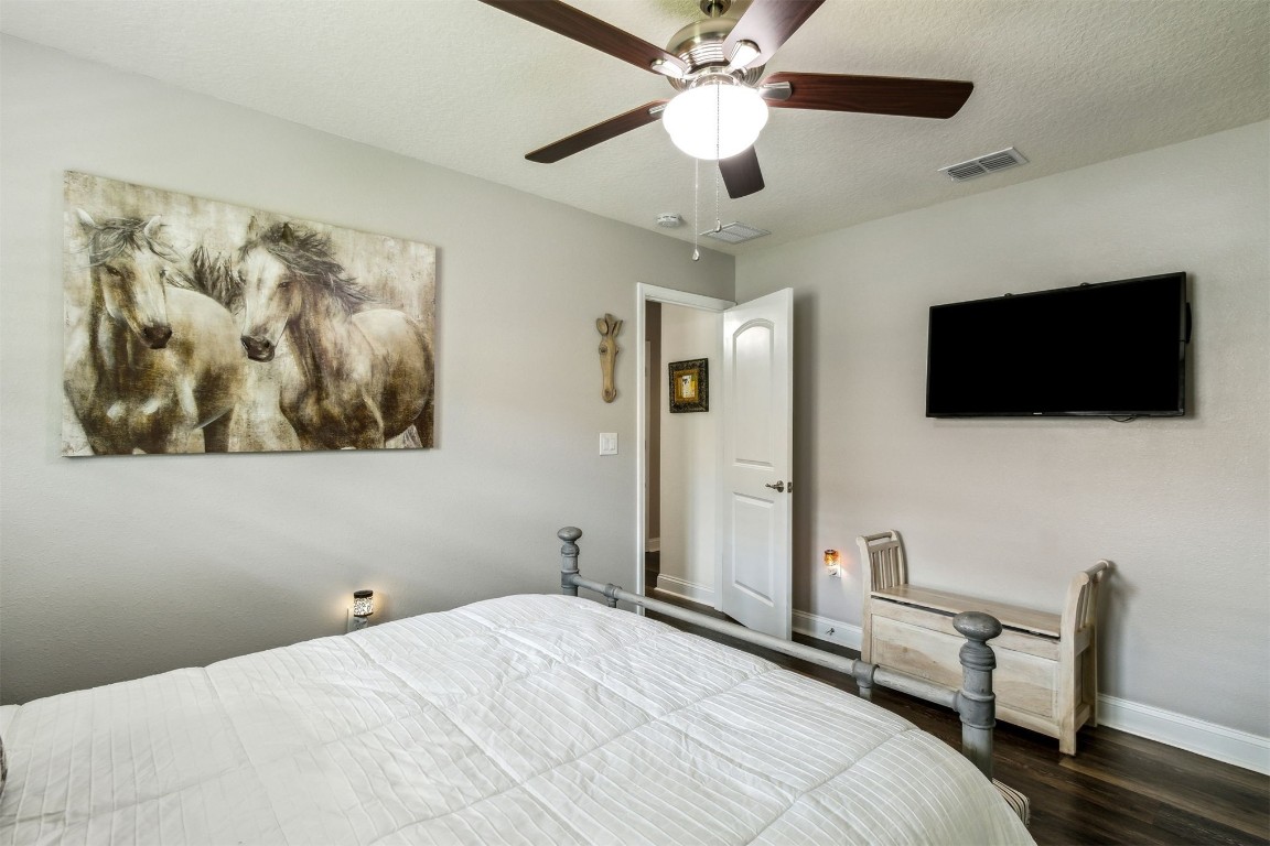 88033 Maybourne Road Yulee, FL 32097 - Photo 31 of 42 a bedroom with a bed and a flat screen tv