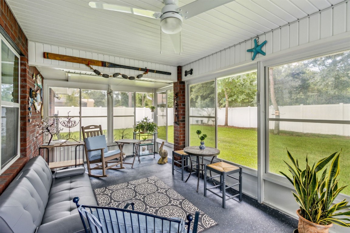 88033 Maybourne Road Yulee, FL 32097 - Photo 38 of 42 a living room with furniture and floor to ceiling windows