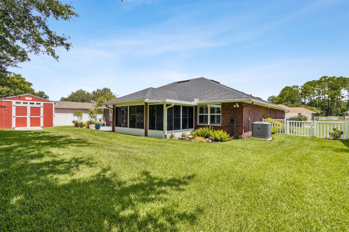 88033 Maybourne Road Yulee, FL 32097 - Photo 4 of 42 a front view of a house with a garden