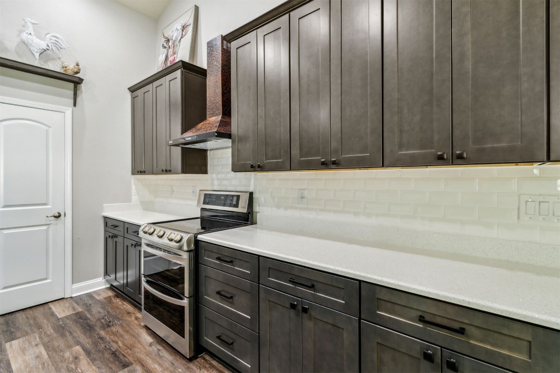88033 Maybourne Road Yulee, FL 32097 - Photo 9 of 42 a kitchen with stainless steel appliances a stove and cabinets