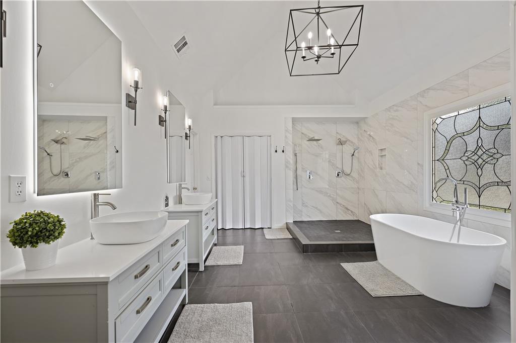 3038 Fairhaven Ridge Northwest Kennesaw, GA 30144 - Photo 19 of 55 a spacious bathroom with a double vanity sink and a bathtub