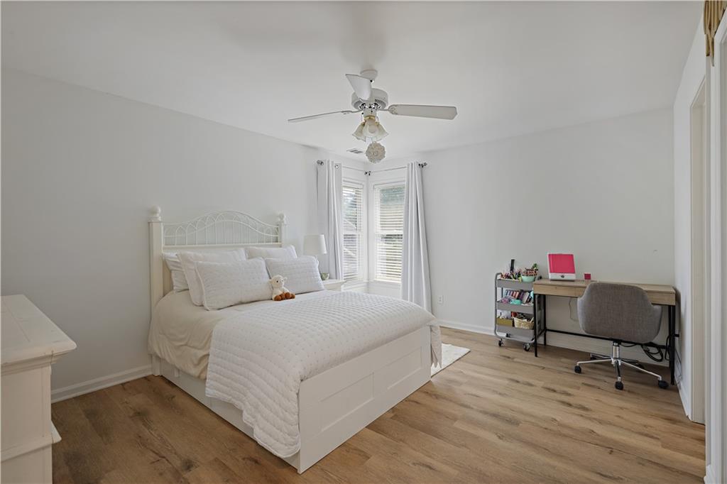 3038 Fairhaven Ridge Northwest Kennesaw, GA 30144 - Photo 21 of 55 a bedroom with a bed and a chandelier