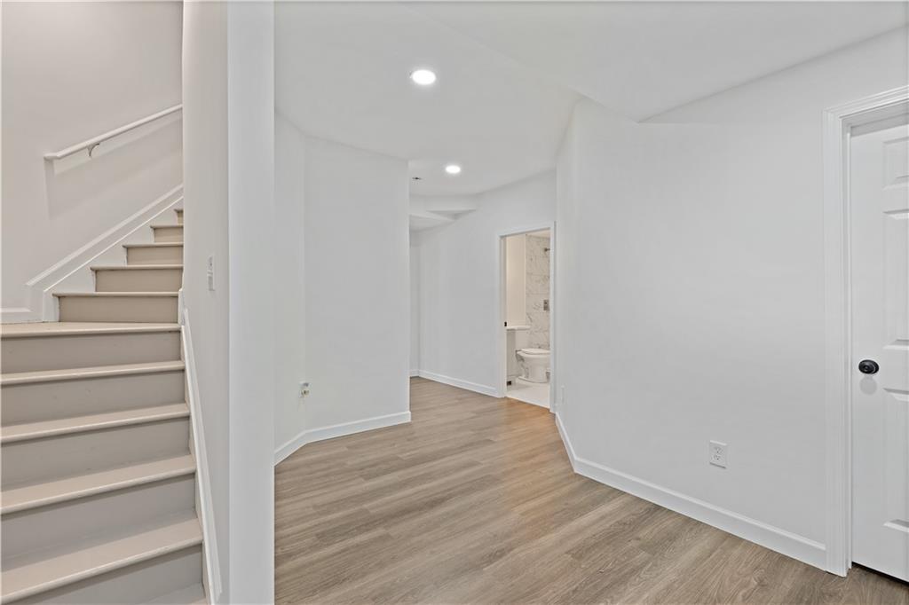 3038 Fairhaven Ridge Northwest Kennesaw, GA 30144 - Photo 31 of 55 a view of an empty room with stairs and wooden floor
