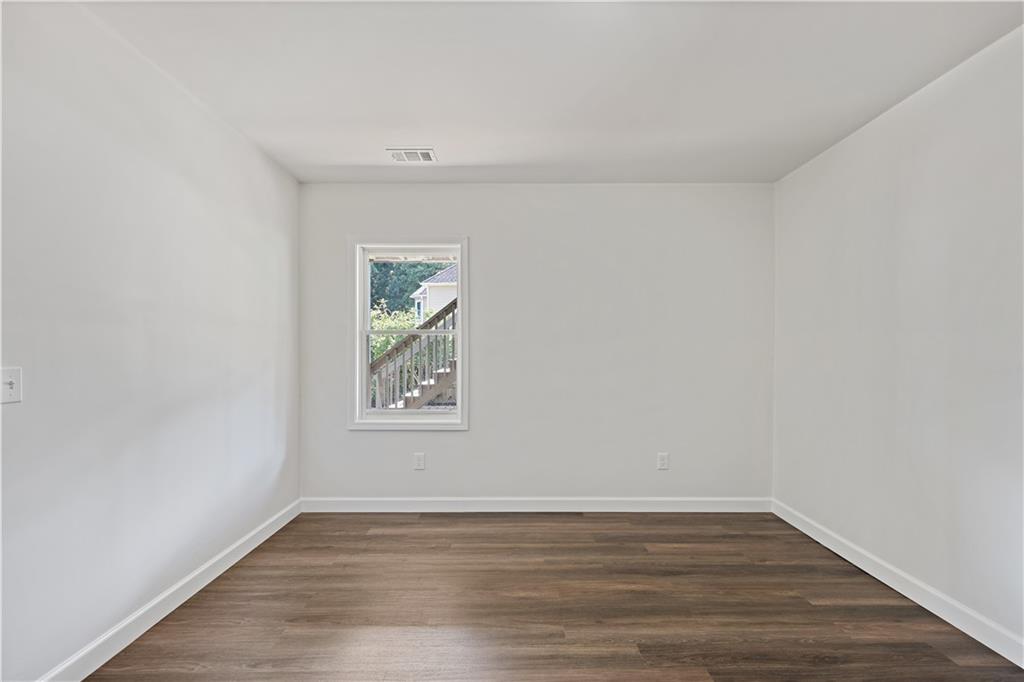 3038 Fairhaven Ridge Northwest Kennesaw, GA 30144 - Photo 34 of 55 a view of an empty room with wooden floor and a window