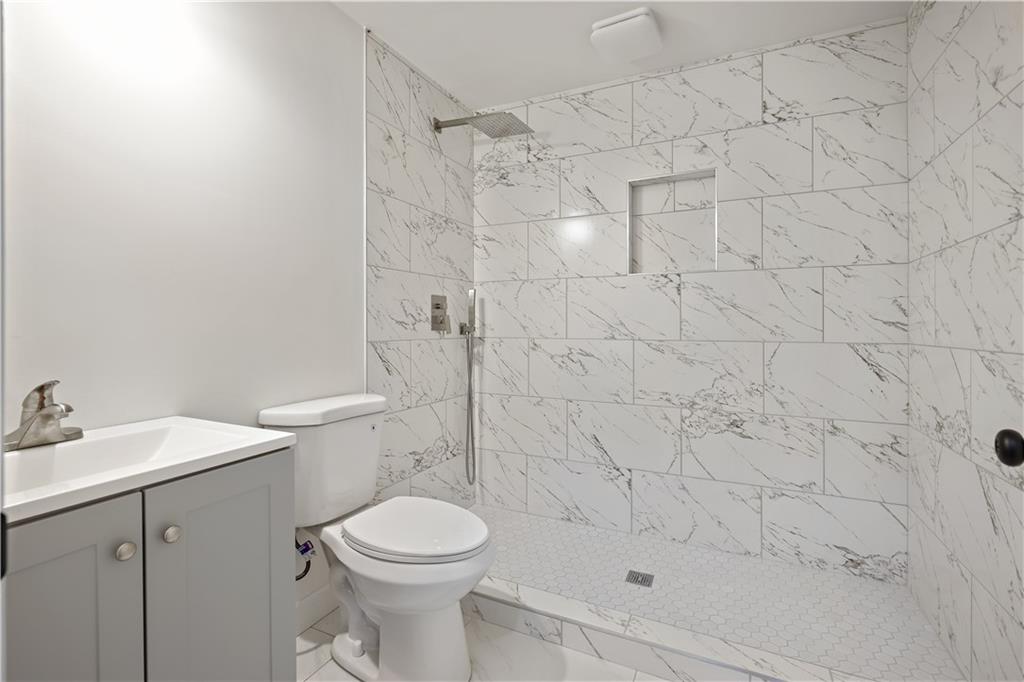 3038 Fairhaven Ridge Northwest Kennesaw, GA 30144 - Photo 35 of 55 a bathroom with a shower toilet and sink