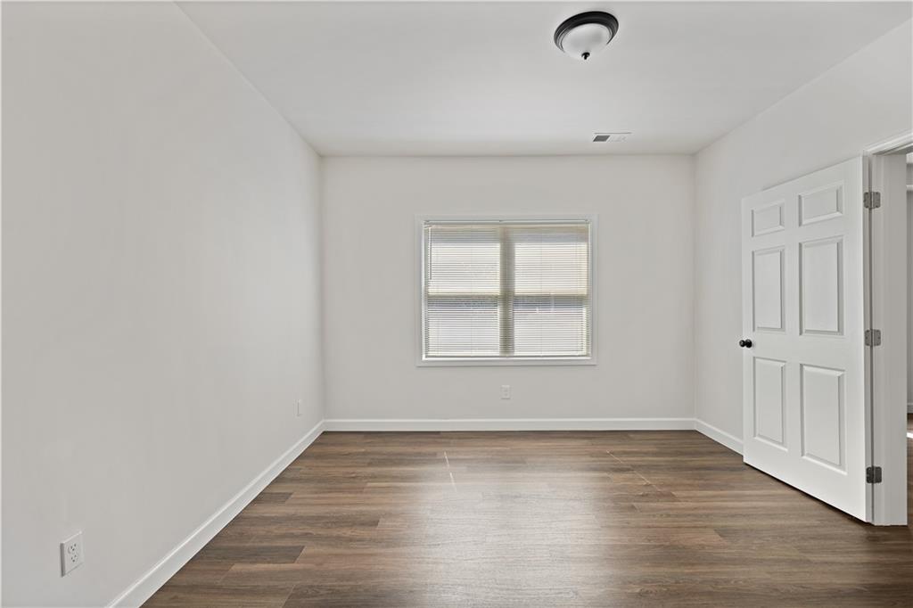 3038 Fairhaven Ridge Northwest Kennesaw, GA 30144 - Photo 36 of 55 an empty room with wooden floor and windows