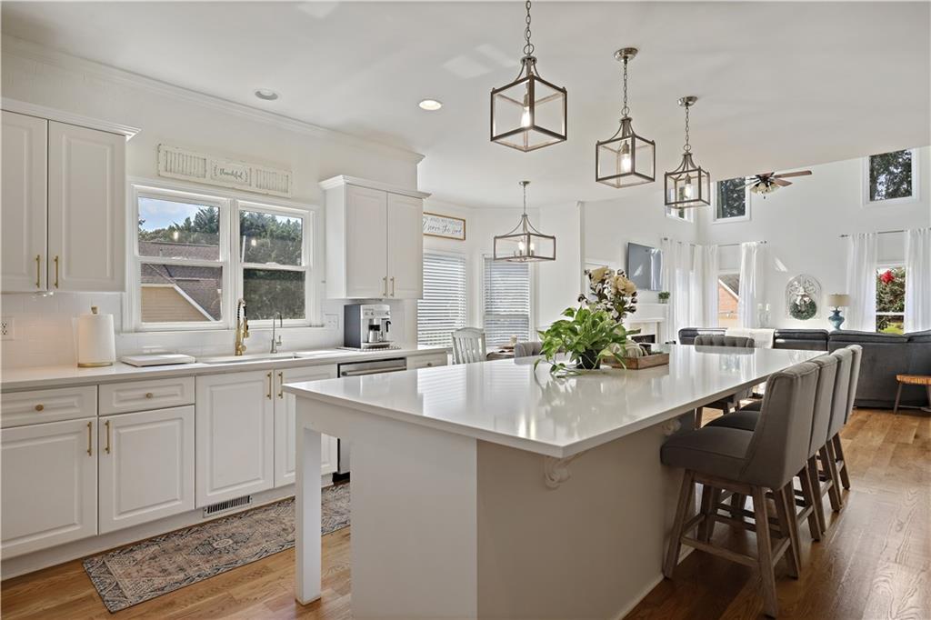 3038 Fairhaven Ridge Northwest Kennesaw, GA 30144 - Photo 5 of 55 a kitchen with center island table and chairs in it
