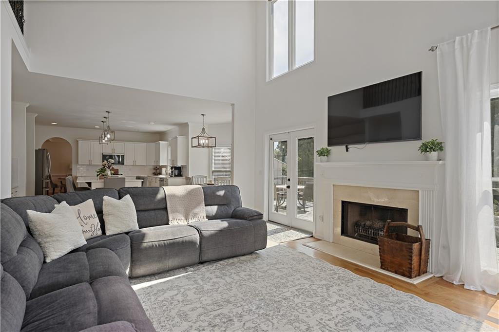 3038 Fairhaven Ridge Northwest Kennesaw, GA 30144 - Photo 7 of 55 a living room with furniture a fireplace and a flat screen tv