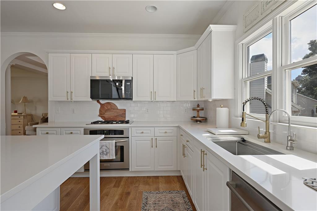 3038 Fairhaven Ridge Northwest Kennesaw, GA 30144 - Photo 9 of 55 a kitchen with a sink stove and cabinets