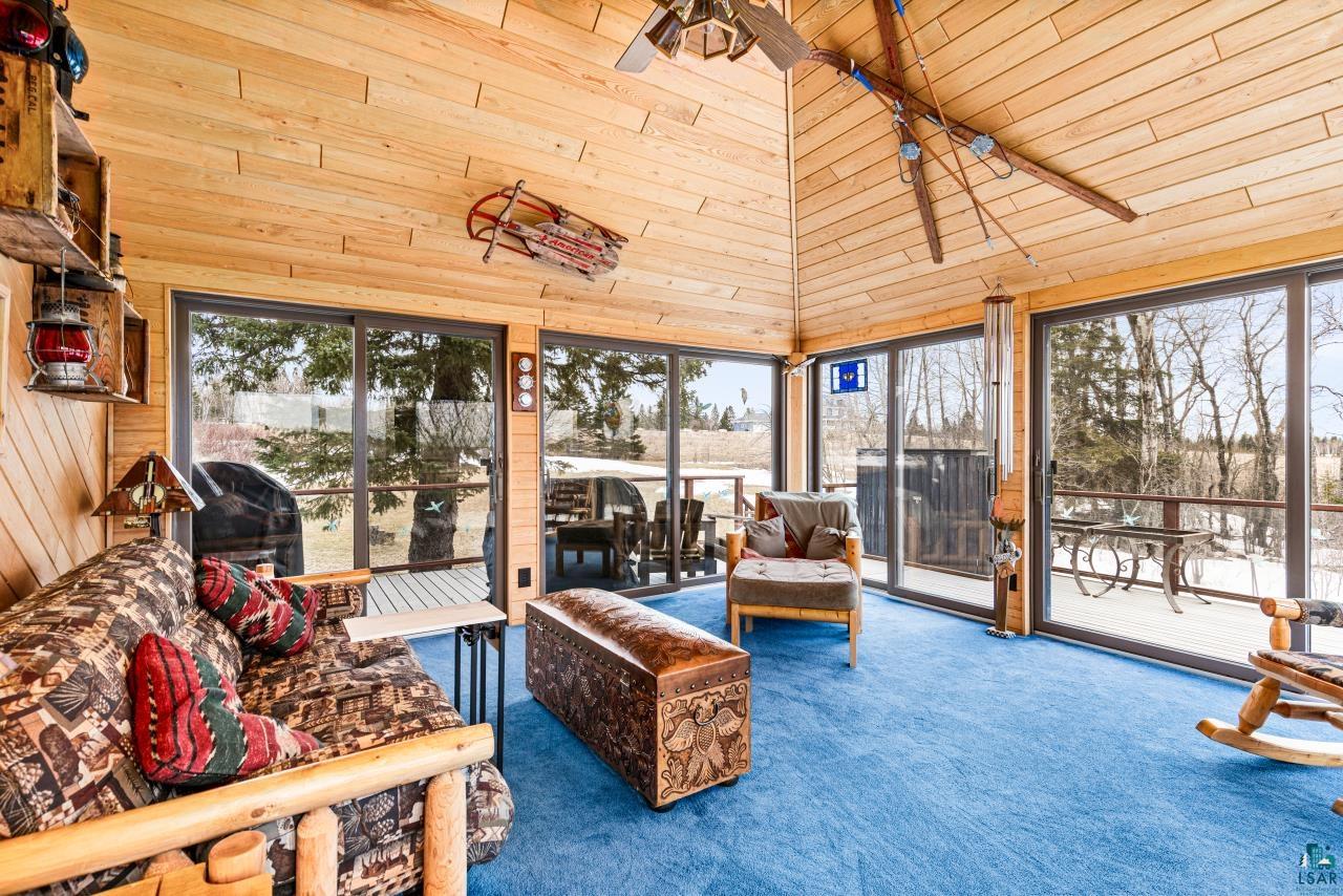 2170 Lester River Road Duluth, MN 55804 - Photo 37 of 66 Sunroom featuring wood walls, carpet floors, and a vaulted wood ceiling
