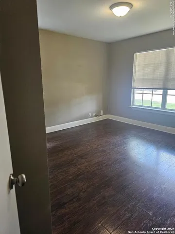 a view of wooden floor and windows in a room