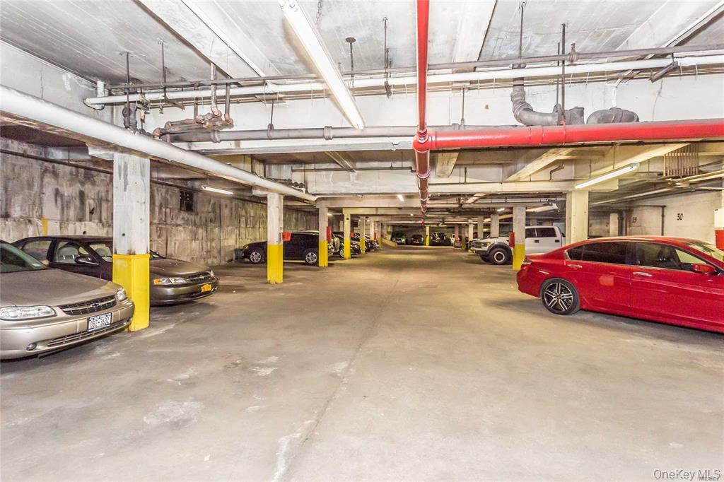 87-10 34th Avenue, Unit 4 Queens, NY 11372 - Photo 5 of 6 a view of parking area with parked cars