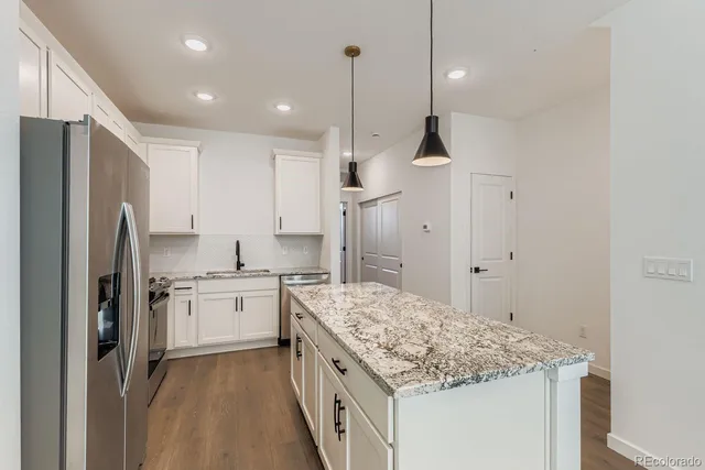 a kitchen with a sink stove and refrigerator