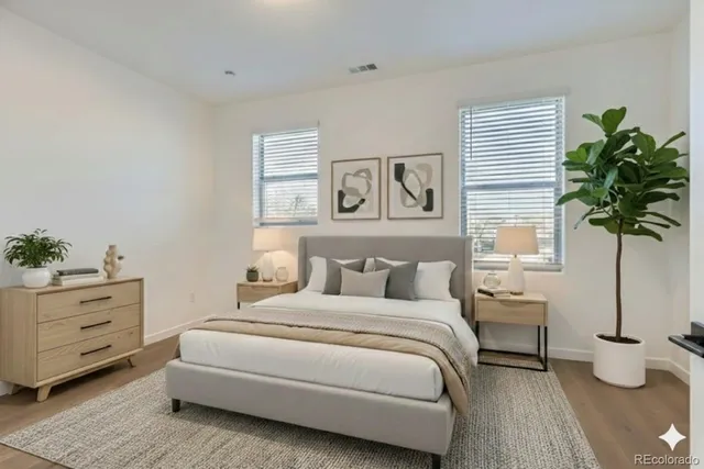 a bedroom with a bed and a potted plant