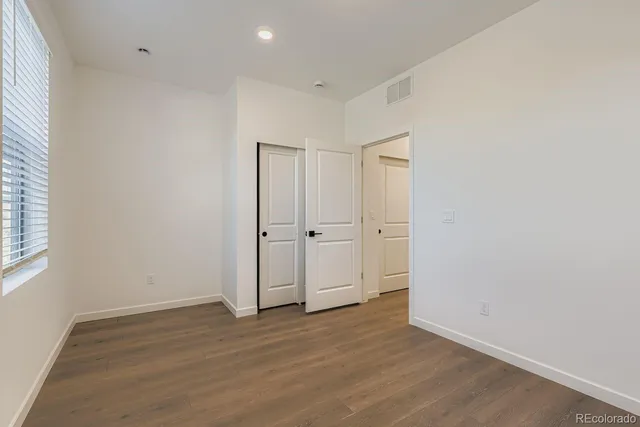 an empty room with wooden floor
