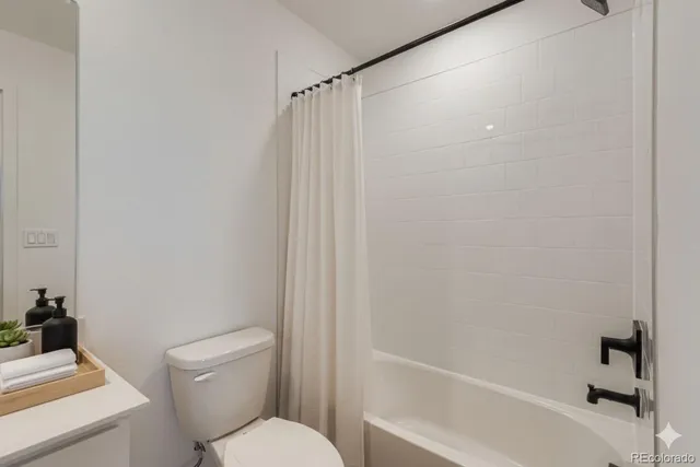a bathroom with a toilet and a bathtub