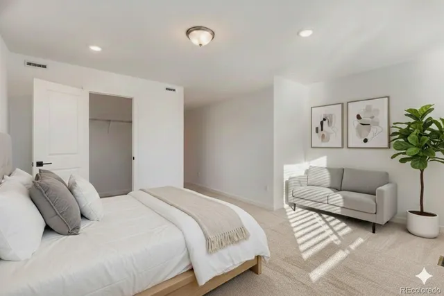 a bedroom with a bed and couch