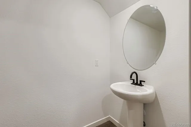 a bathroom with a sink and mirror
