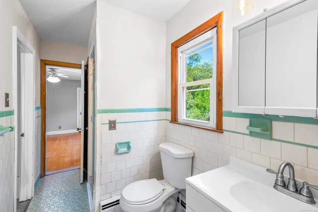 a white toilet sitting next to a bathroom sink