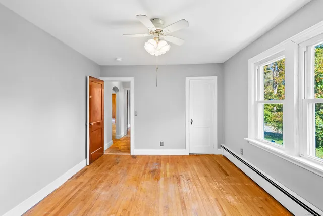 wooden floor in an empty room with a window