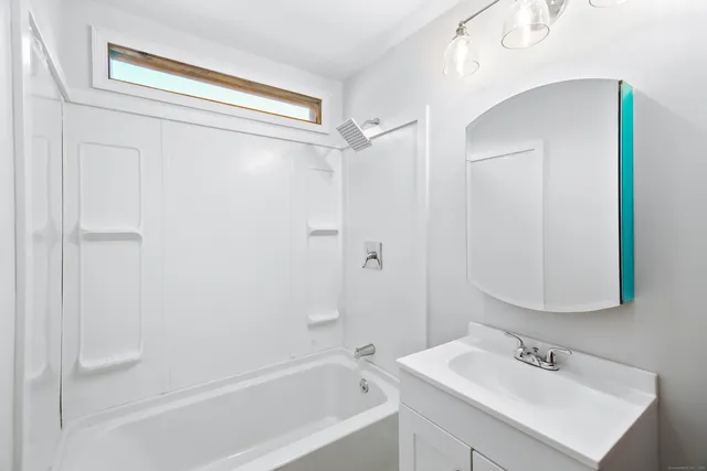 a bathroom with a bathtub and a sink