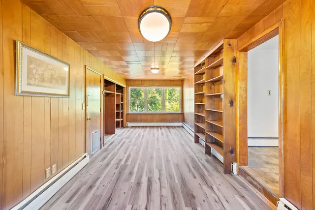 a view of a room with wooden floor and window