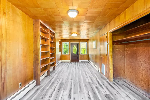 a view of a balcony with wooden floor and furniture