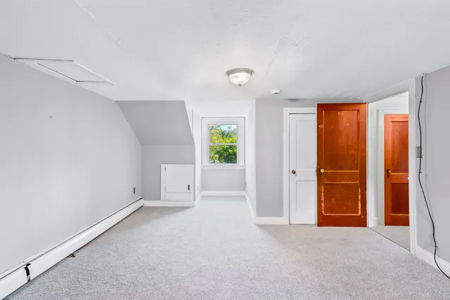 an empty room with windows and closet