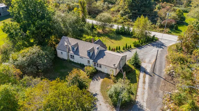 an aerial view of a house with garden space and sitting area