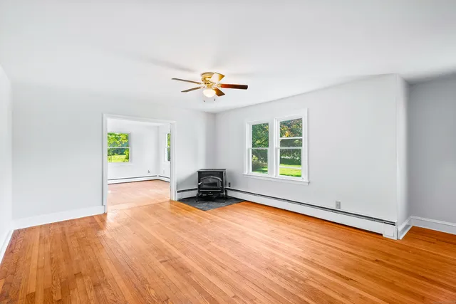 wooden floor in an empty room with a window