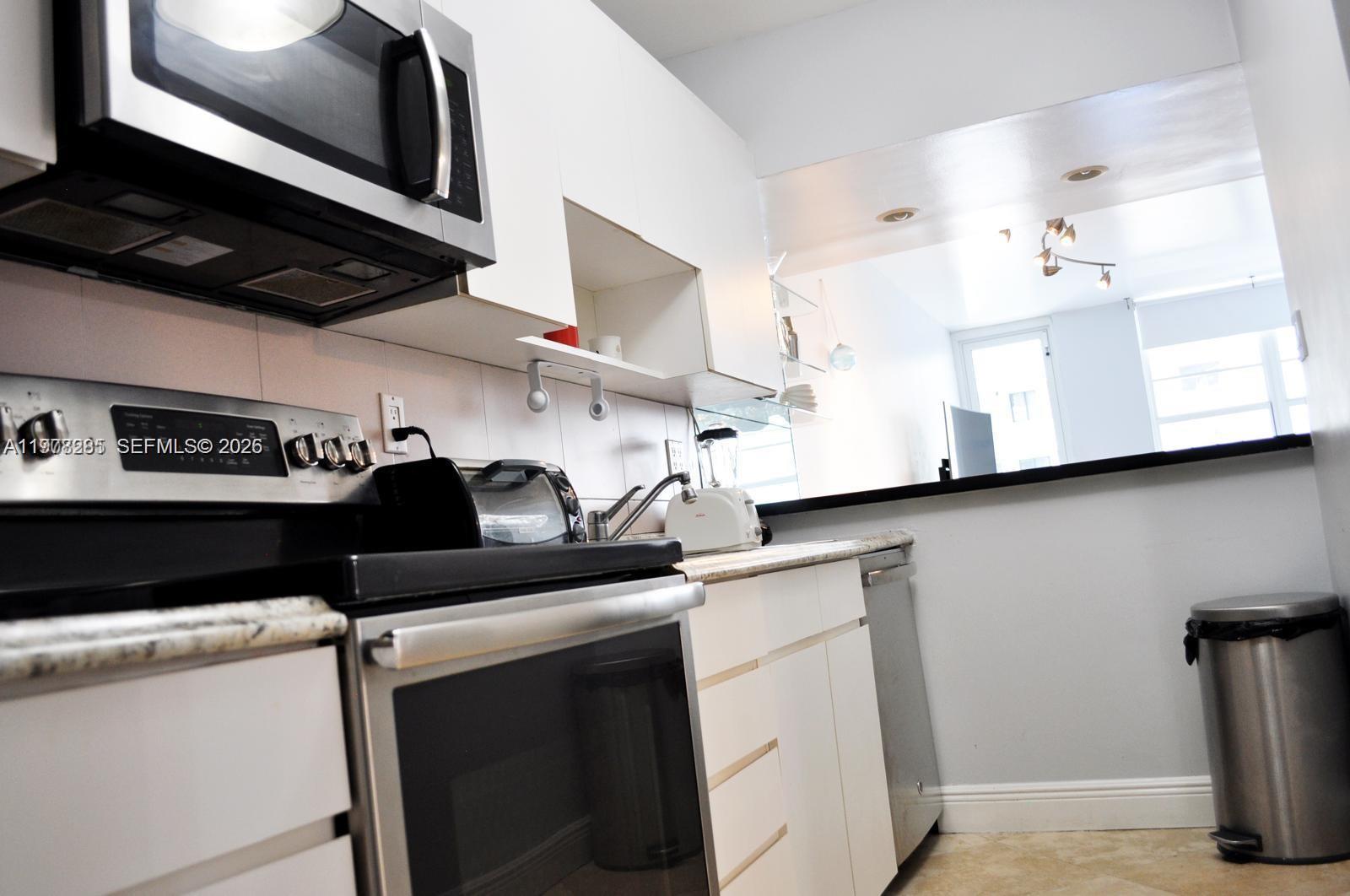 100 Lincoln Road, Unit 728 Miami Beach, FL 33139 - Photo 3 of 8 a kitchen with a sink and cabinets