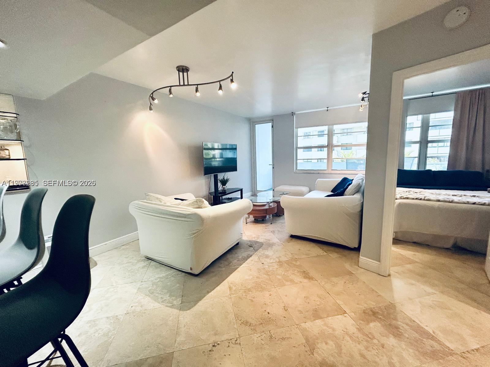 100 Lincoln Road, Unit 728 Miami Beach, FL 33139 - Photo 7 of 8 a living room with furniture and window