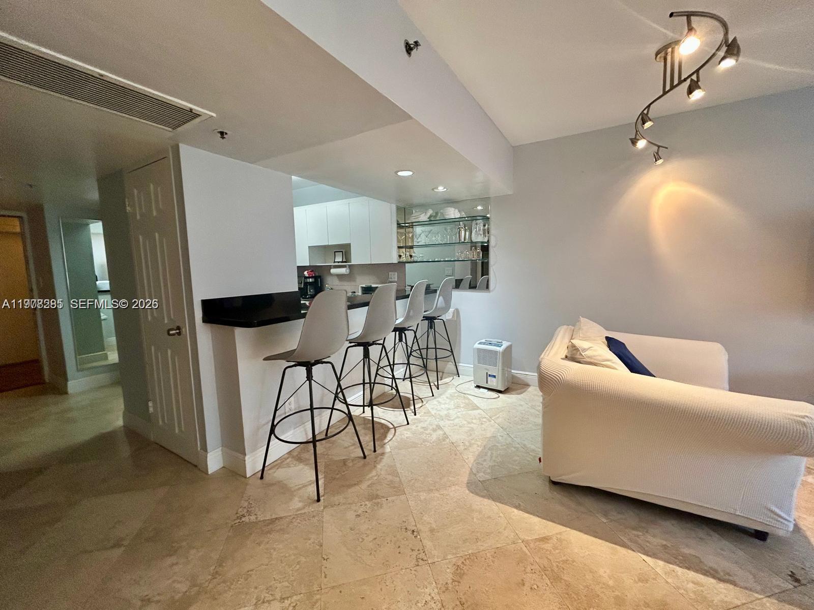 100 Lincoln Road, Unit 728 Miami Beach, FL 33139 - Photo 8 of 8 a living room with furniture and a dining table with kitchen view