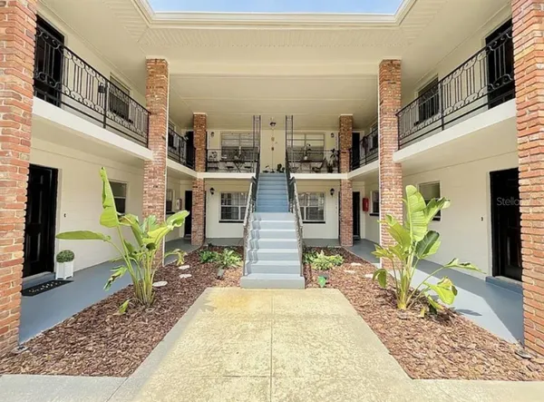 a front view of a house with outdoor seating