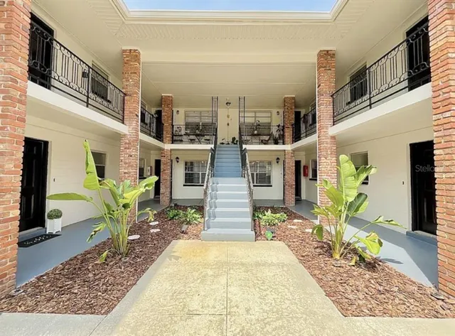 a front view of a house with outdoor seating