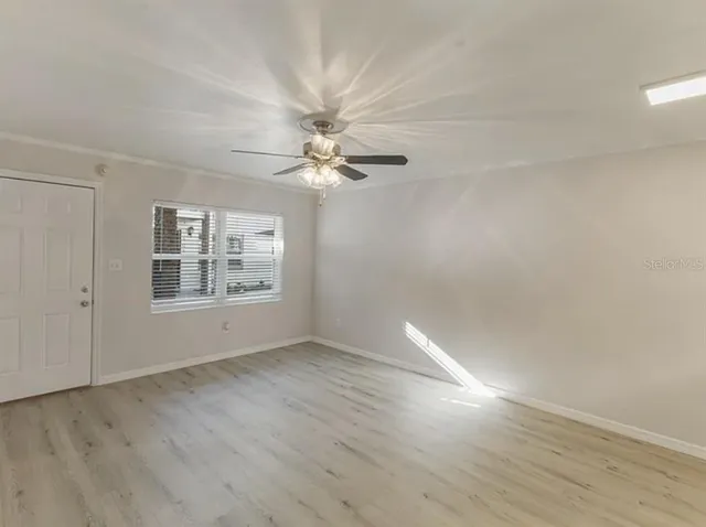 wooden floor in an empty room with a window