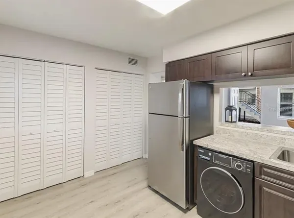 a utility room with cabinets washer and dryer